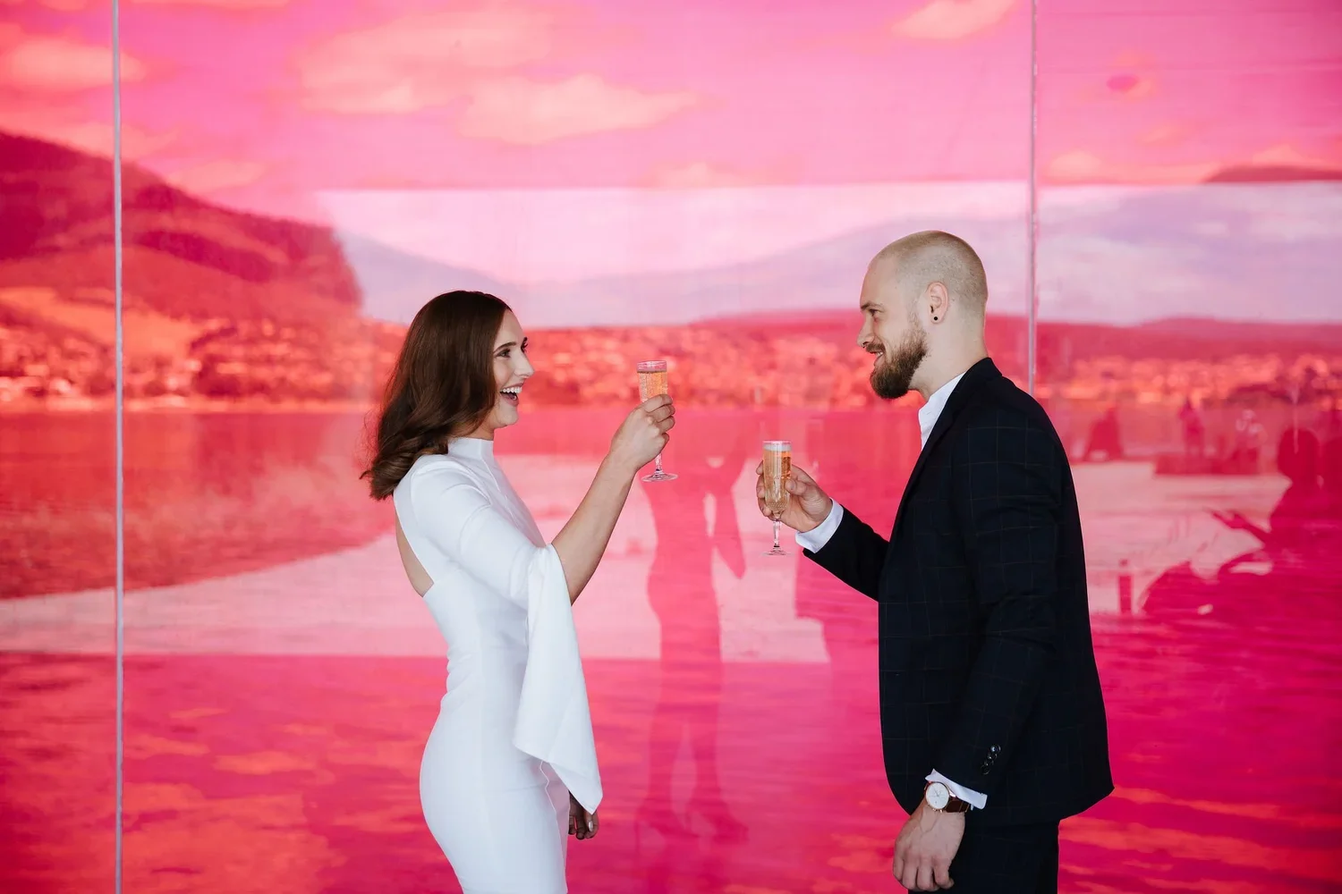 Couple celebrating with champagne after eloping at MONA Tasmania with I Do Drive Thru — elopement packages from $400