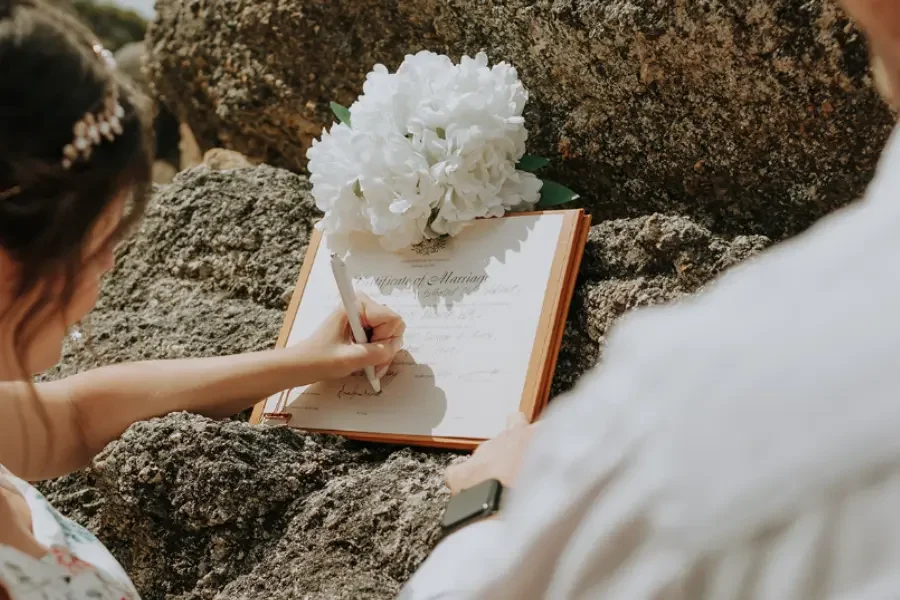 Couple signing their elopement paperwork at their home in Rockhampton with I Do Drive Thru — elopement celebrant from $400