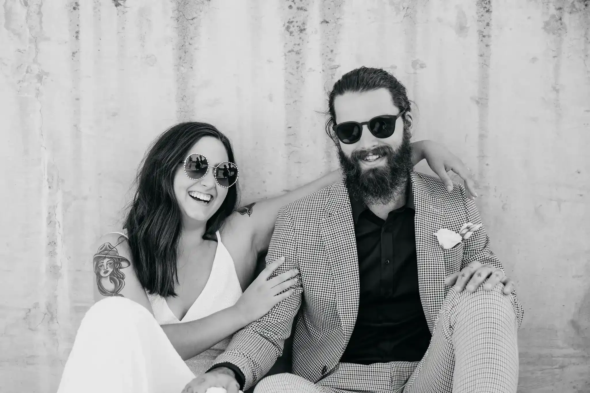 Couple leaning against a wall on main street Rockhampton after eloping with I Do Drive Thru — elopement celebrant from $400