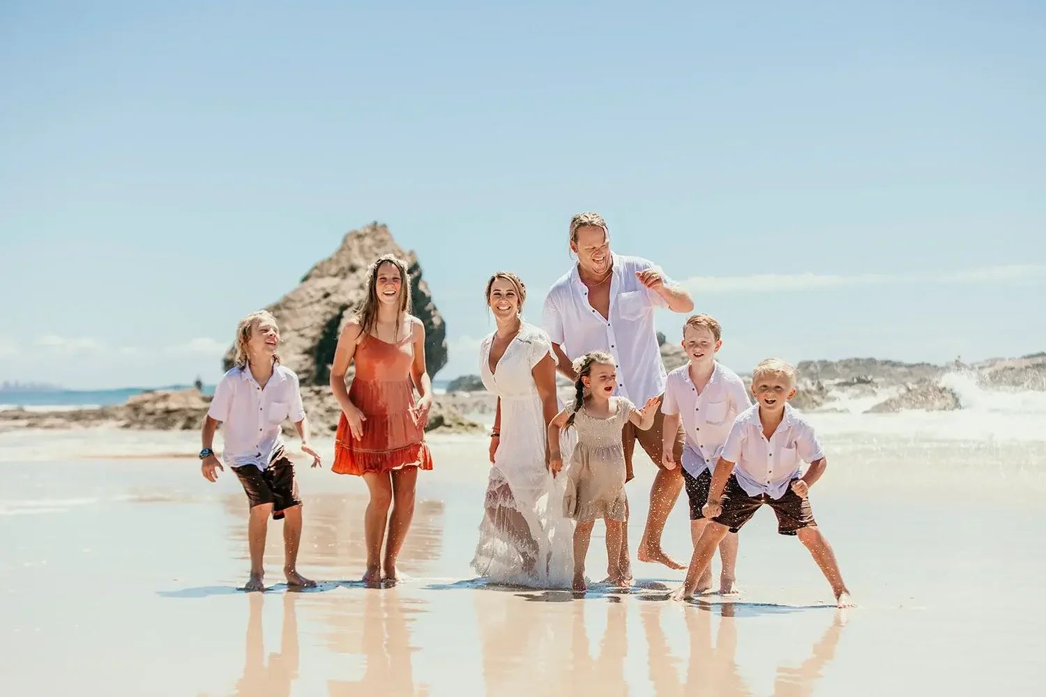 Couple marrying on the Gold Coast beach surrounded by their children with I Do Drive Thru — family elopement from $400