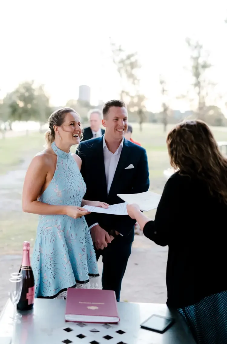 Couple signing their legal marriage paperwork at Albert Park Lake Melbourne with I Do Drive Thru — from $400
