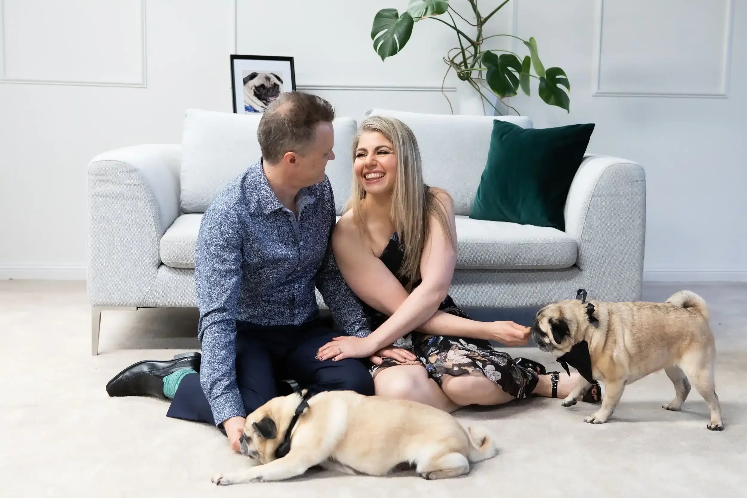 Couple with their dogs doing portraits in their lounge room after eloping at home with I Do Drive Thru — home wedding celebrant from $400