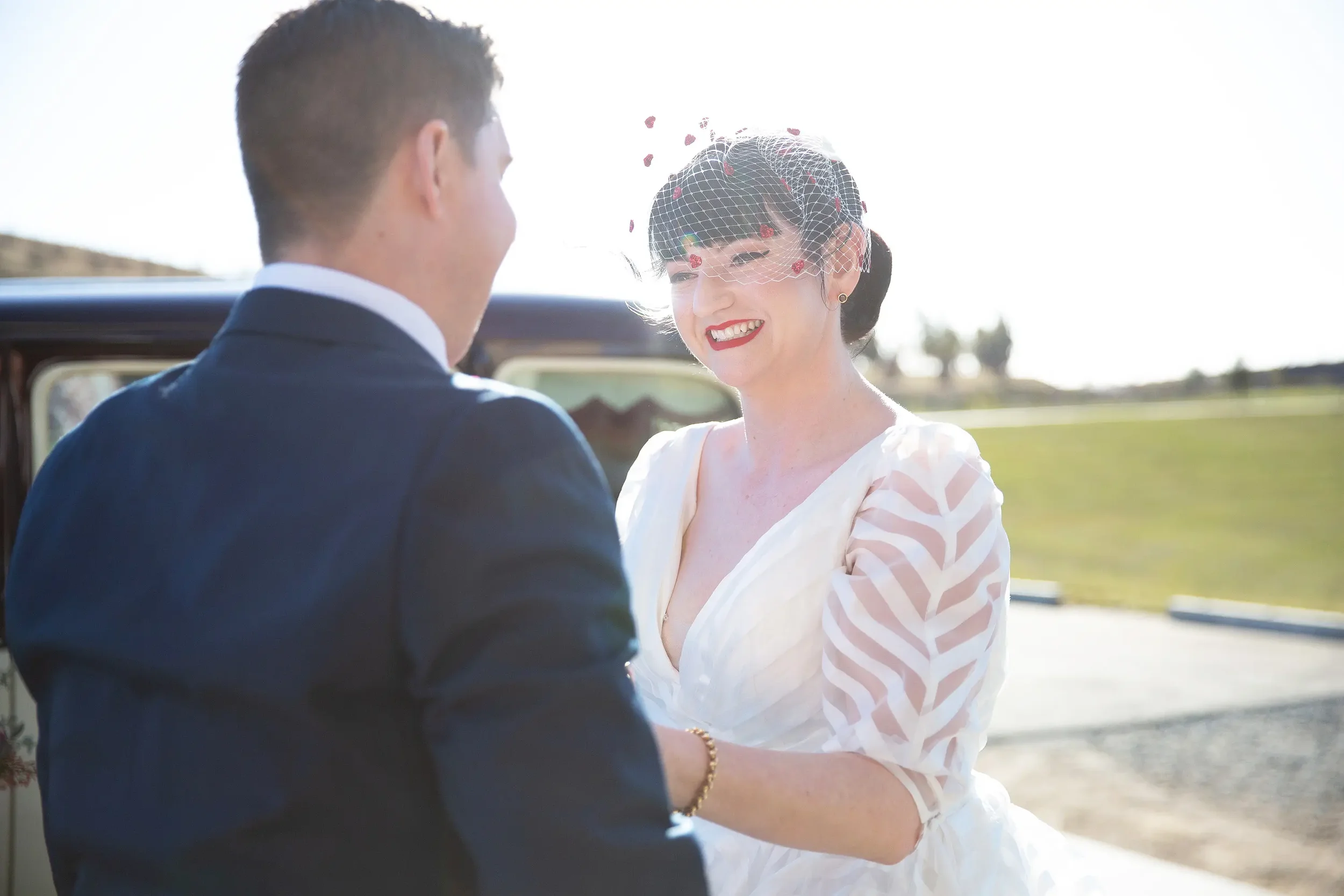 Bride smiling after seeing her groom at the National Arboretum Canberra with I Do Drive Thru — elopement celebrant from $400