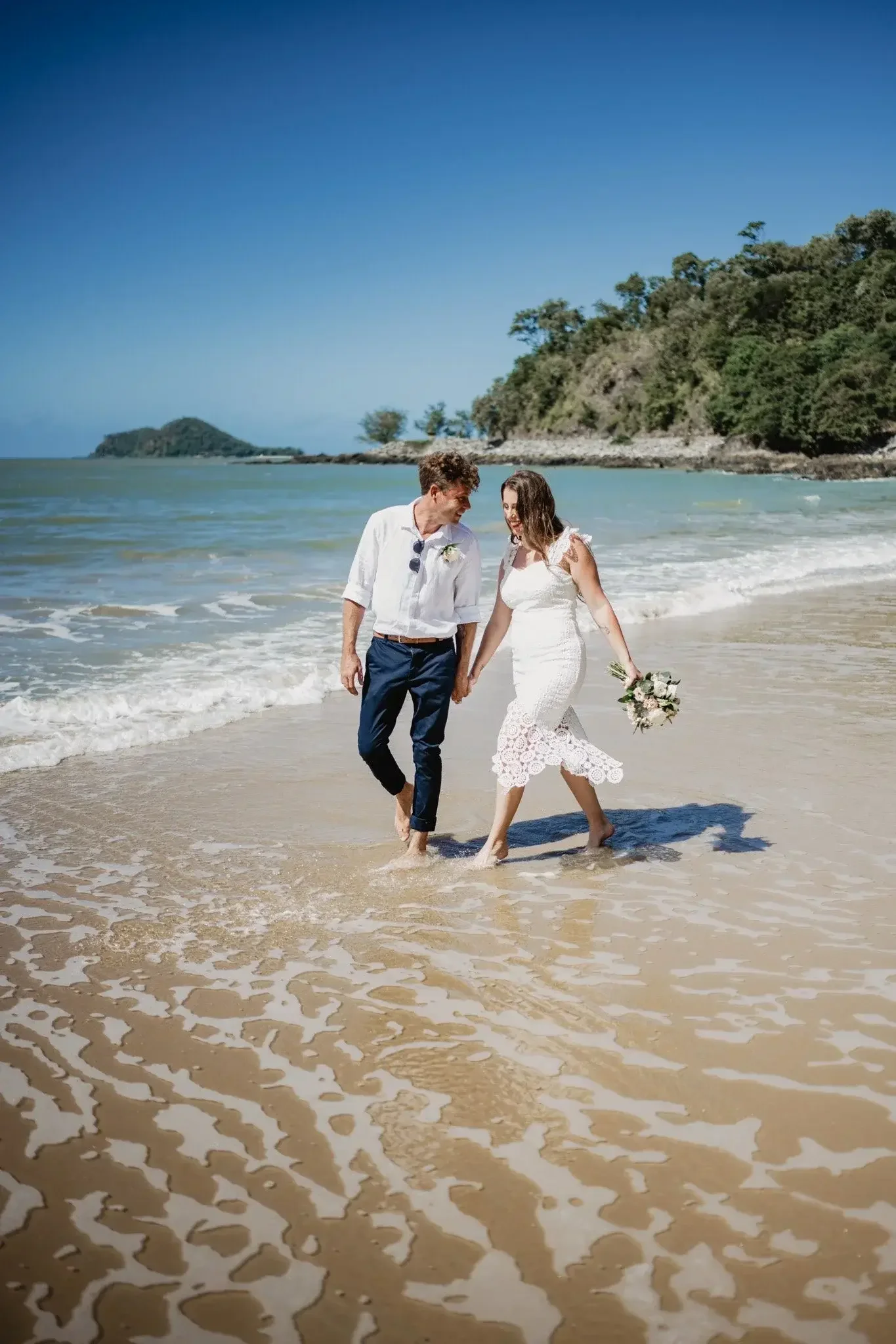Couple walking into the water after eloping on the Gold Coast beach with I Do Drive Thru — beach elopement from $400