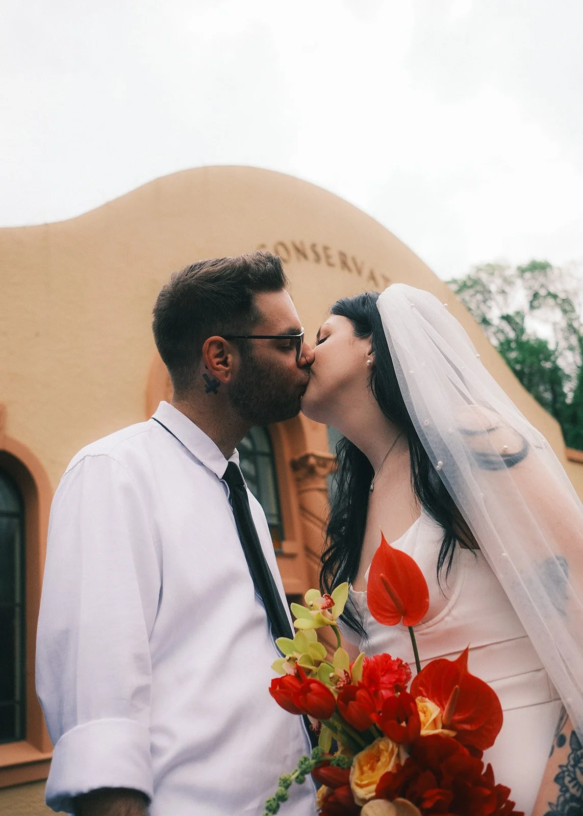 Couple kissing outside the Fitzroy Gardens Conservatory Melbourne after their elopement ceremony with I Do Drive Thru