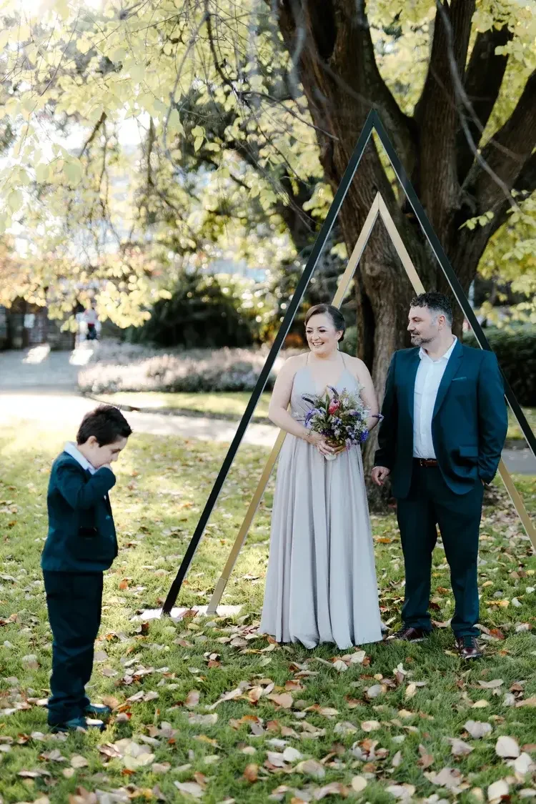 Couple eloping with their son at Fitzroy Gardens Melbourne with I Do Drive Thru — family park elopement from $400