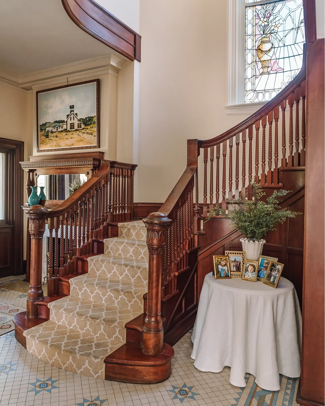 The warm wood tones and soft cream runner create the perfect backdrop to let the patterned tile floor shine. Together, the palette balances richness with lightness &mdash; highlighting the craftsmanship of the wood while drawing the eye to the intric
