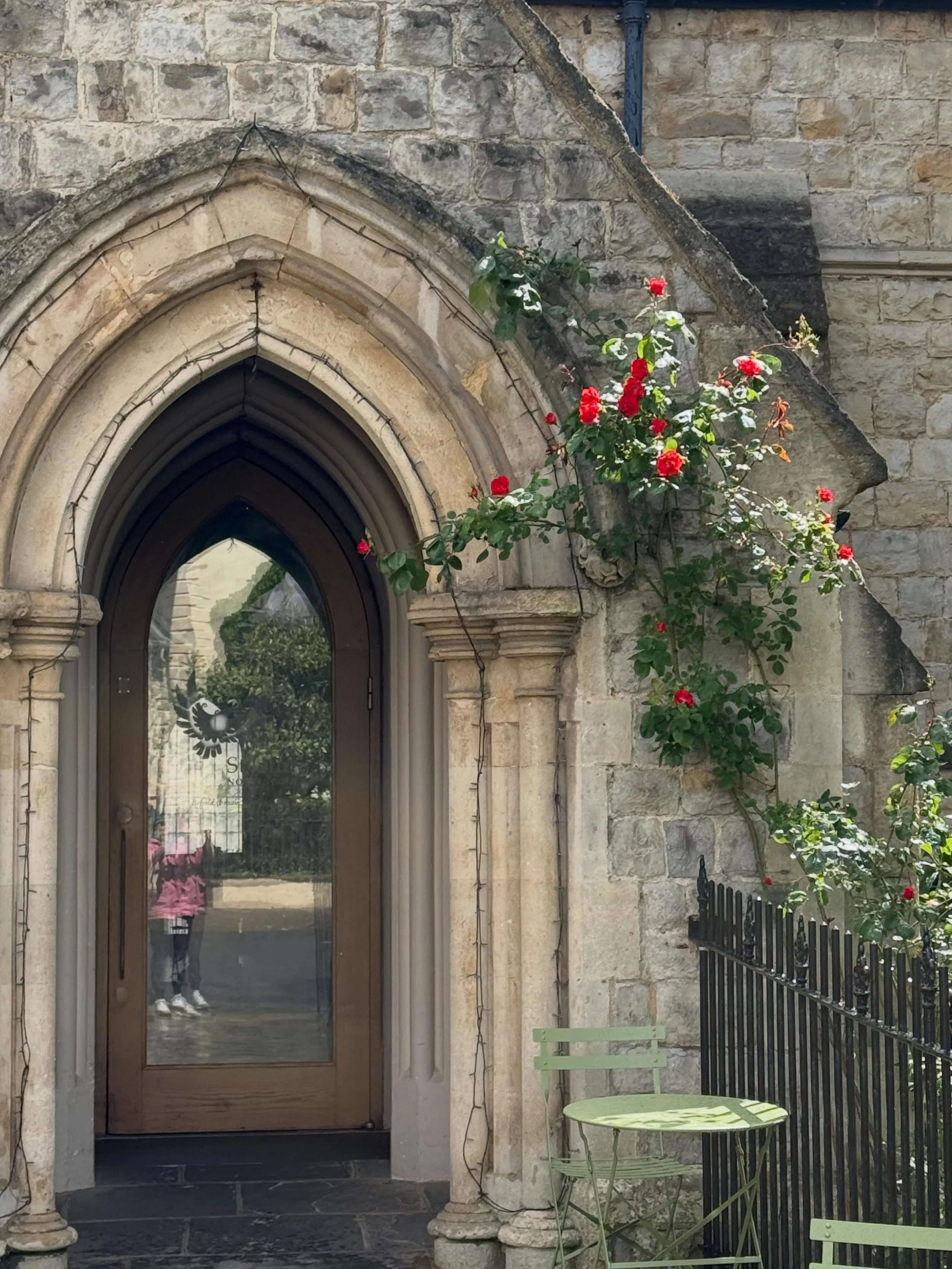 Amid hail, rain and thunder, how cheering to see May roses blooming over the church door at @stjohnsnottinghill .
