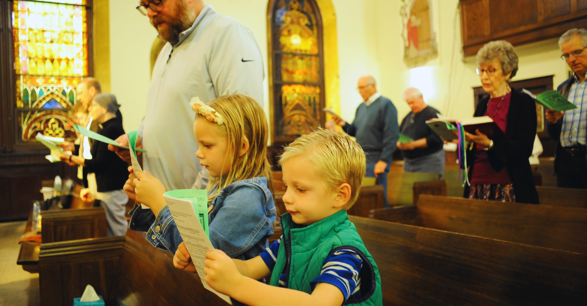 Two young children sing hymns at Bethany Lutheran’s Sunday service.