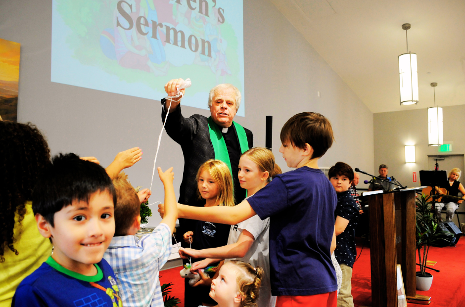 During an interactive children’s sermon, Pastor Remo Madsen (center) shares a joyful moment with younger members of the congregation. Occasions such as these reflect the church’s deep commitment to nurturing faith in children.