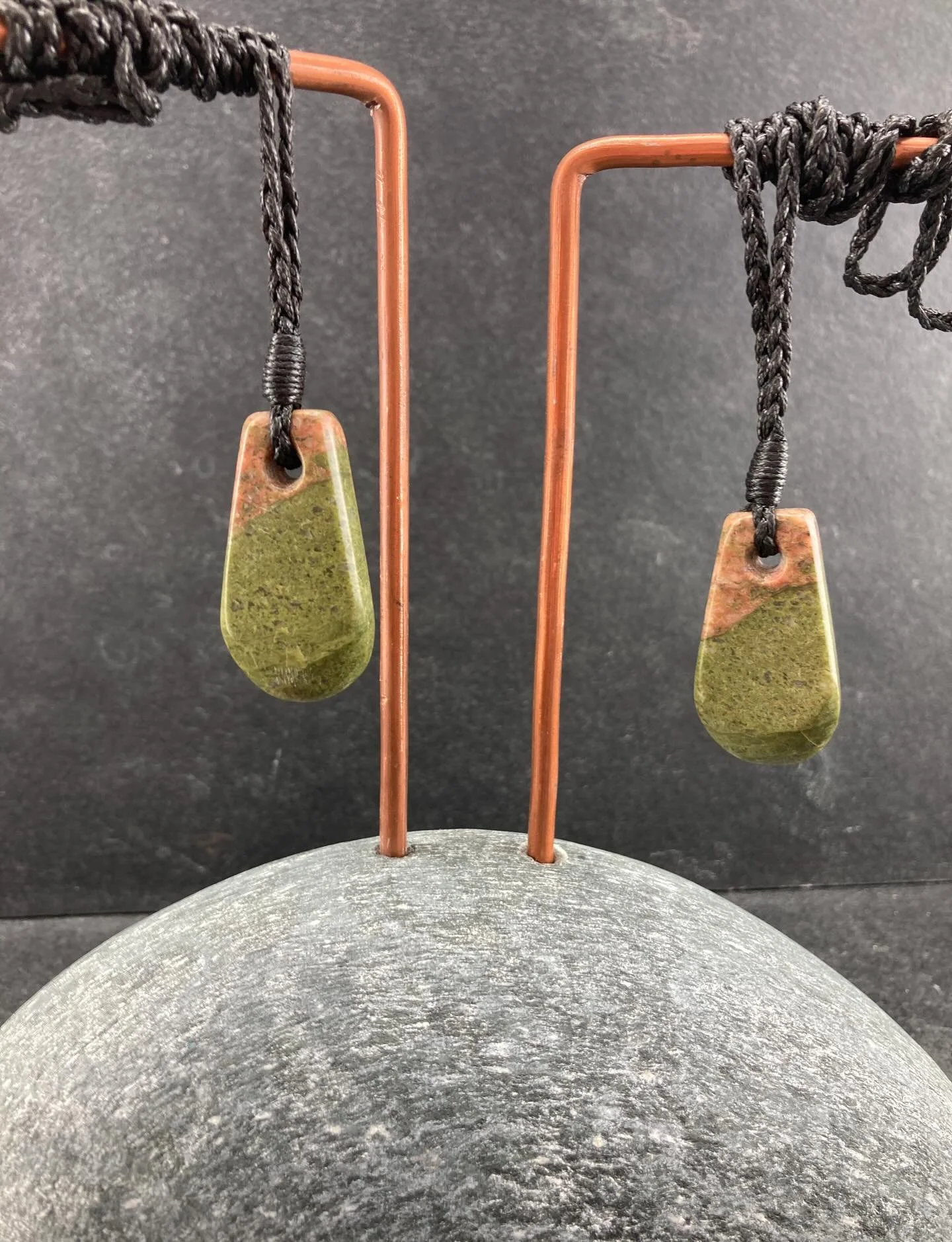 This beautiful stone was just crying out to be carved into a special matched set of pendants.

Including the natural join between two brightly coloured rocks and finished with a braided adjustable cord, this is a one off pair.

Perfect for keeping on