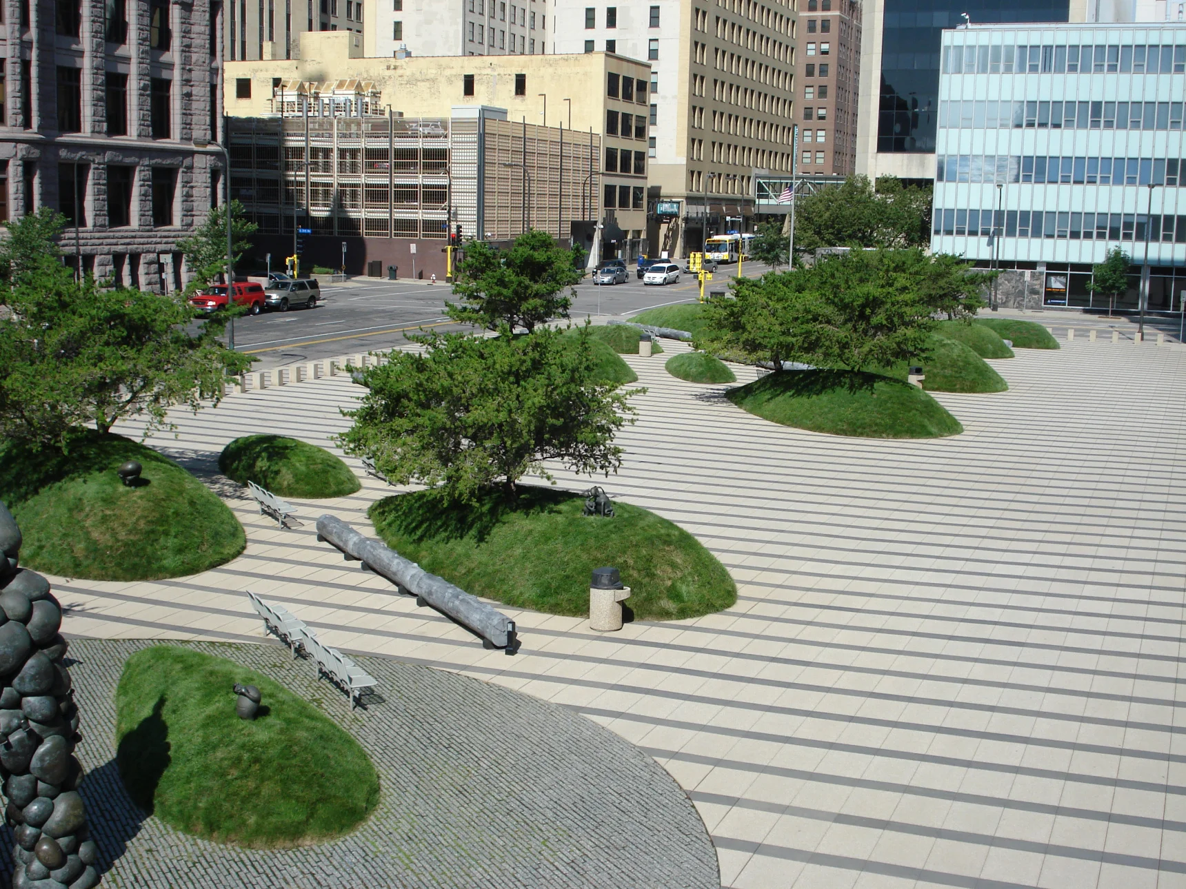 Federal Courthouse Minneapolis MN. Designed by Martha Schwartz Partners, these turf mounds represent drumlin deposits left by glaciers but are actually a clever security feature protecting the buildings while providing artistic and environmental interest. This iconic property is an urban treasure that our team proudly maintains.