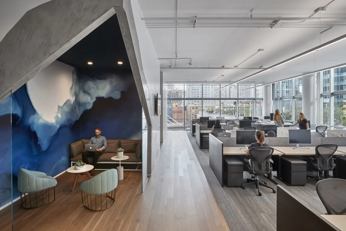 A bright blue plaster mural depicts the full moon in a breakout area.