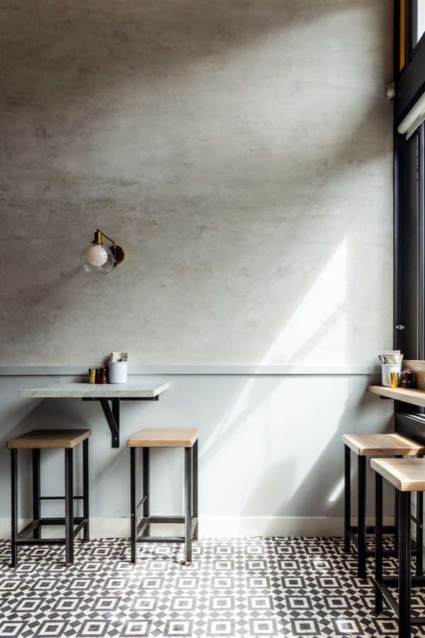 The blue and grey plaster walls complement the patterned tile floor.