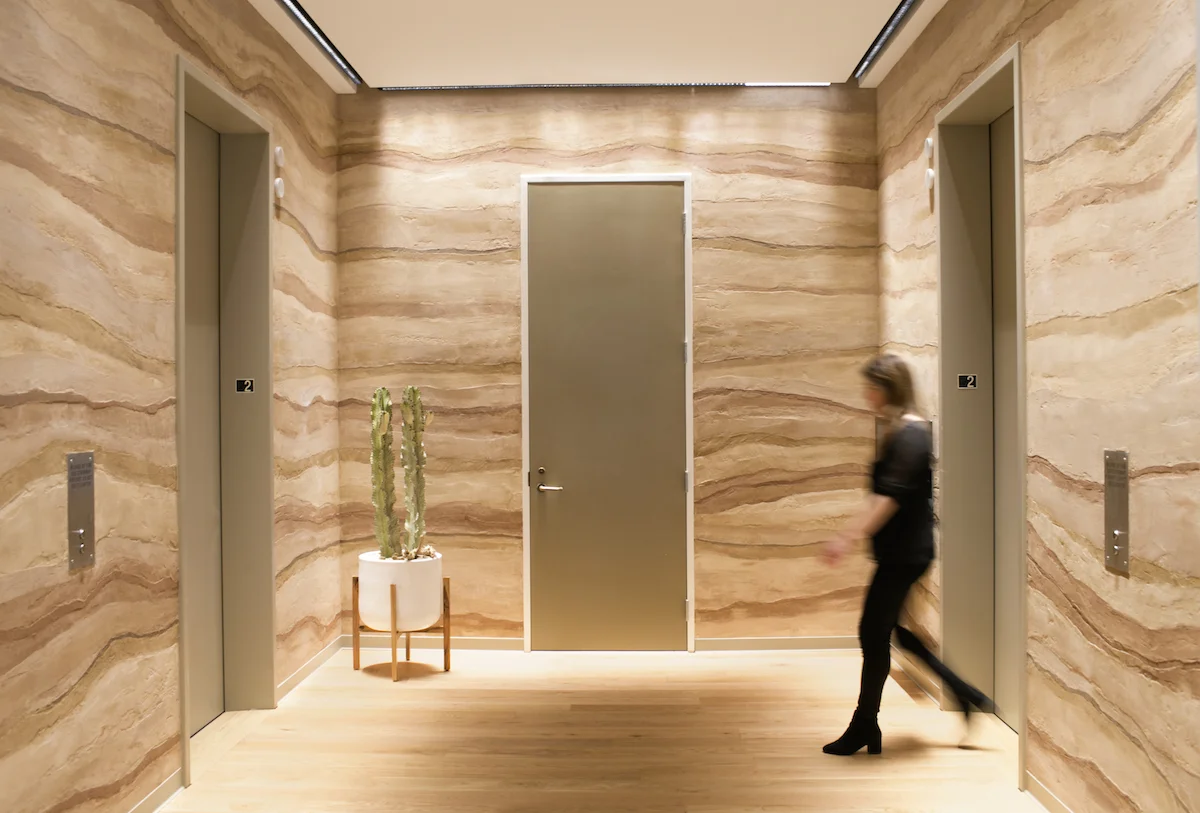 One floor’s lobby has a desert canyon-like appearance from a layered plaster finish.
