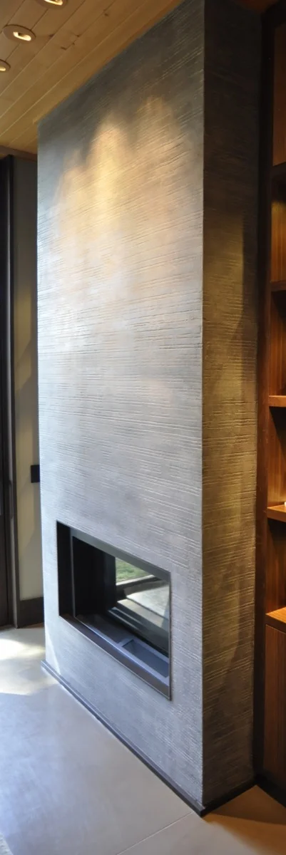 Horizontal grooves and artistic distressing add dimension to the fireplace.