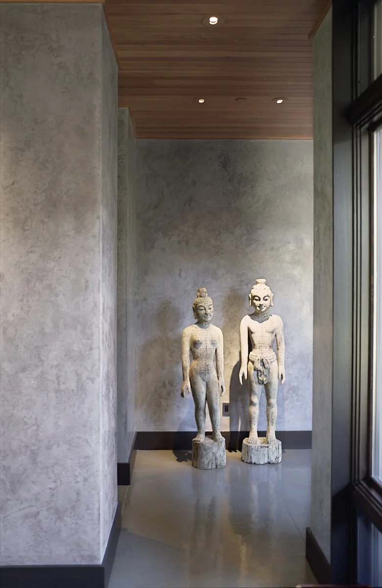 The wall is used as the background for art in the hallway.