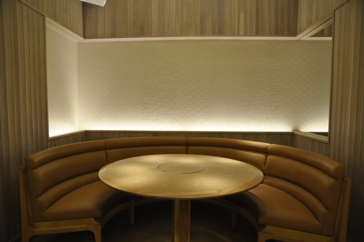 An artistic plaster panel becomes art above a dining booth.