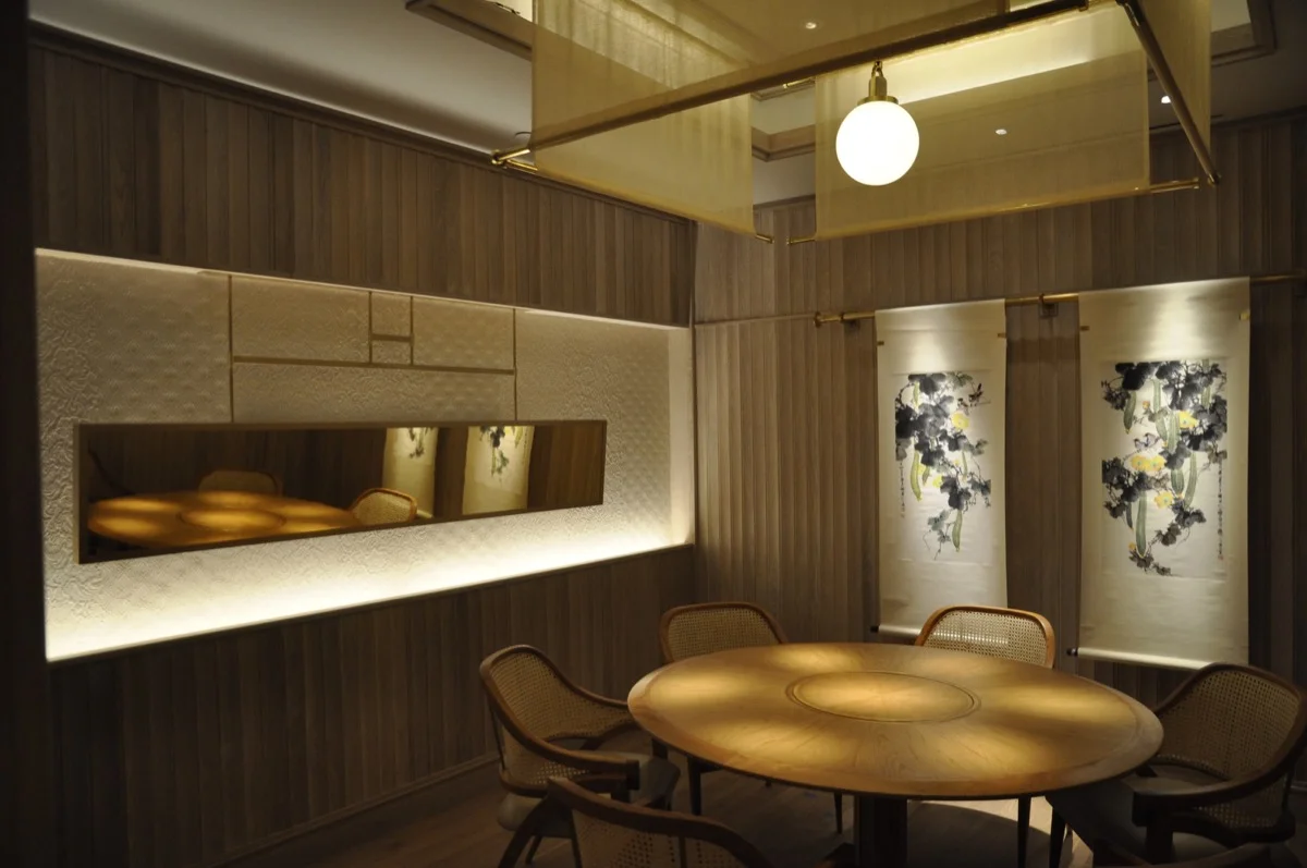 An elegant dining room is elevated by plaster finishes.