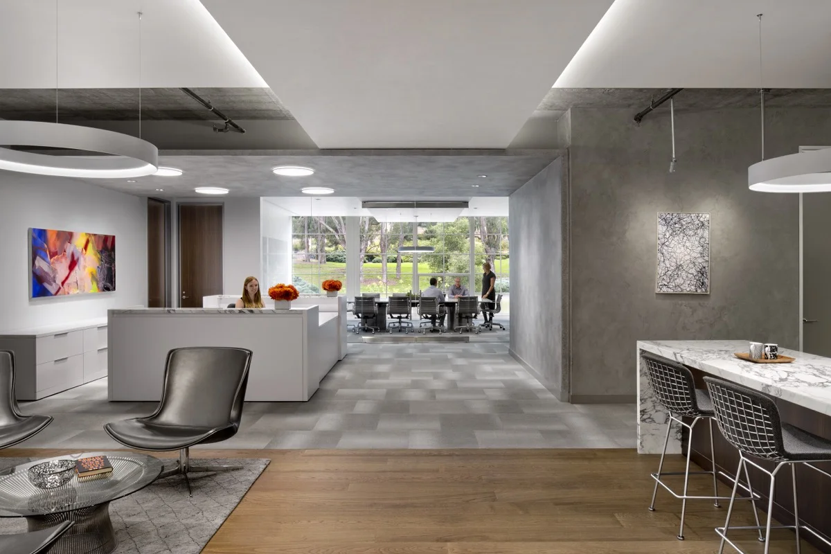 The lobby has a mix of grey and white plaster wall finishes.