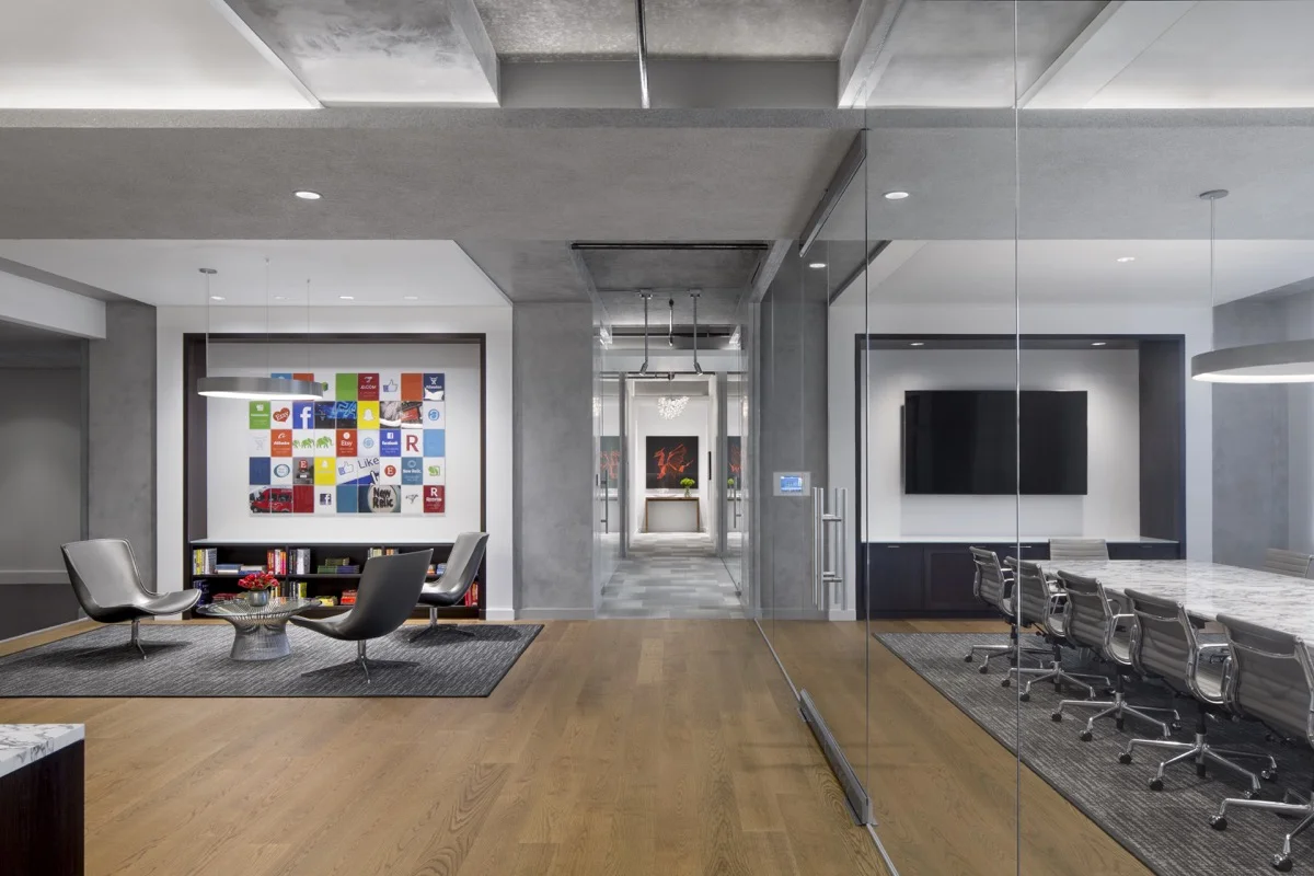 The grey finish continues into the glass walled conference room creating visual connection.