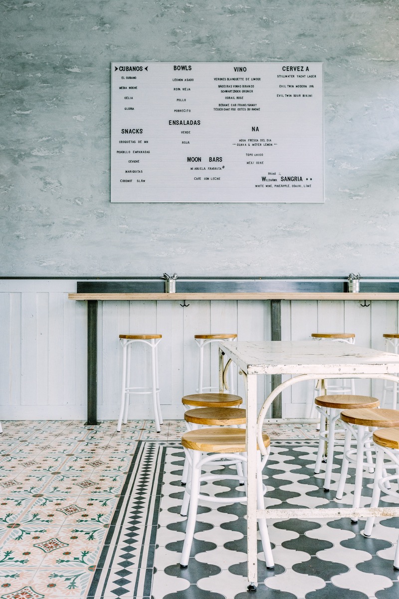 The restaurant’s menu against the two-toned rustic plaster finish.