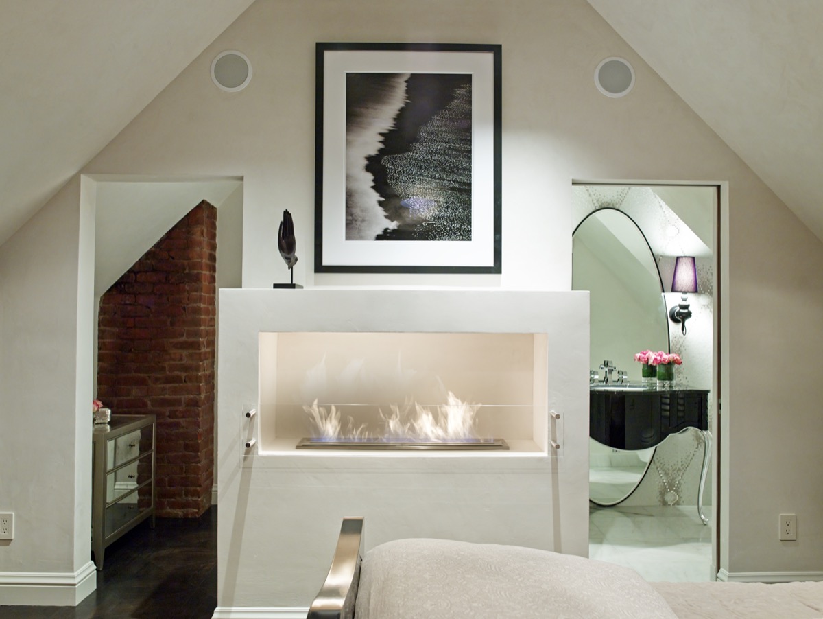 An off-white plaster fireplace warms a room.