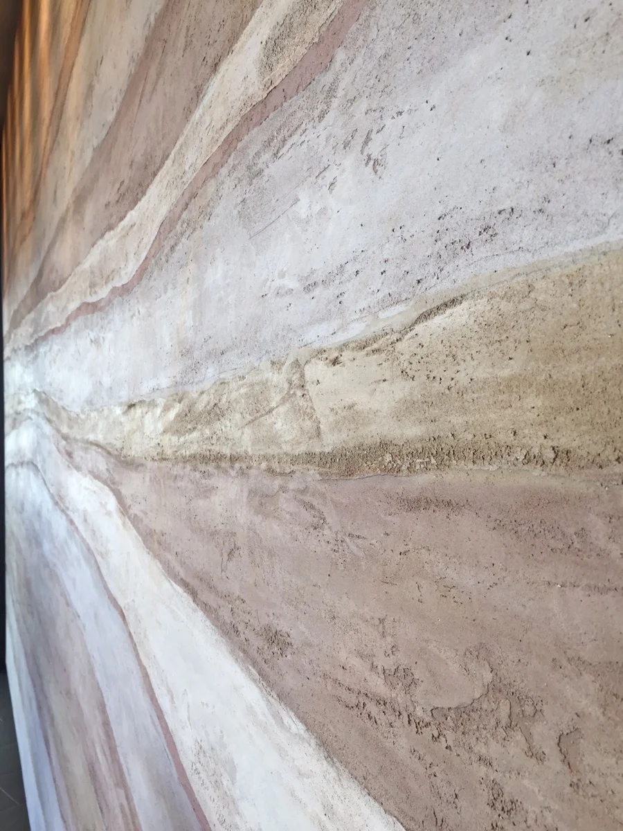 A close up of the integral color plaster wall.