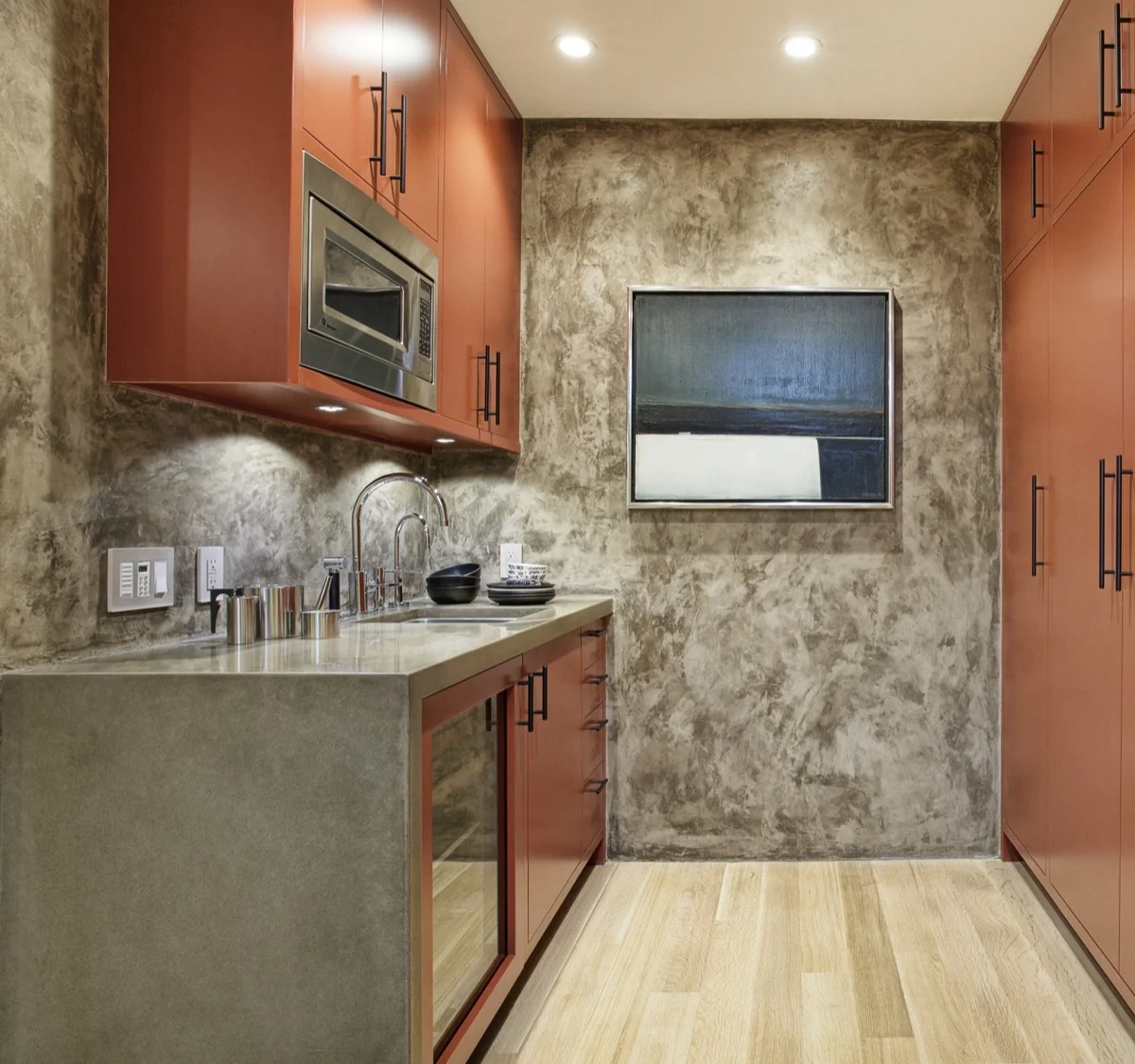 A more distressed wall creates movement in the basement kitchen.