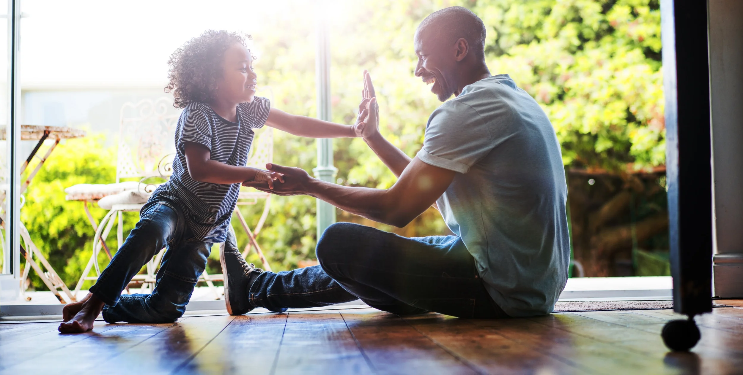 Happy-father-and-son-playing-on-floor-at-home-516178258_7240x4829.jpeg