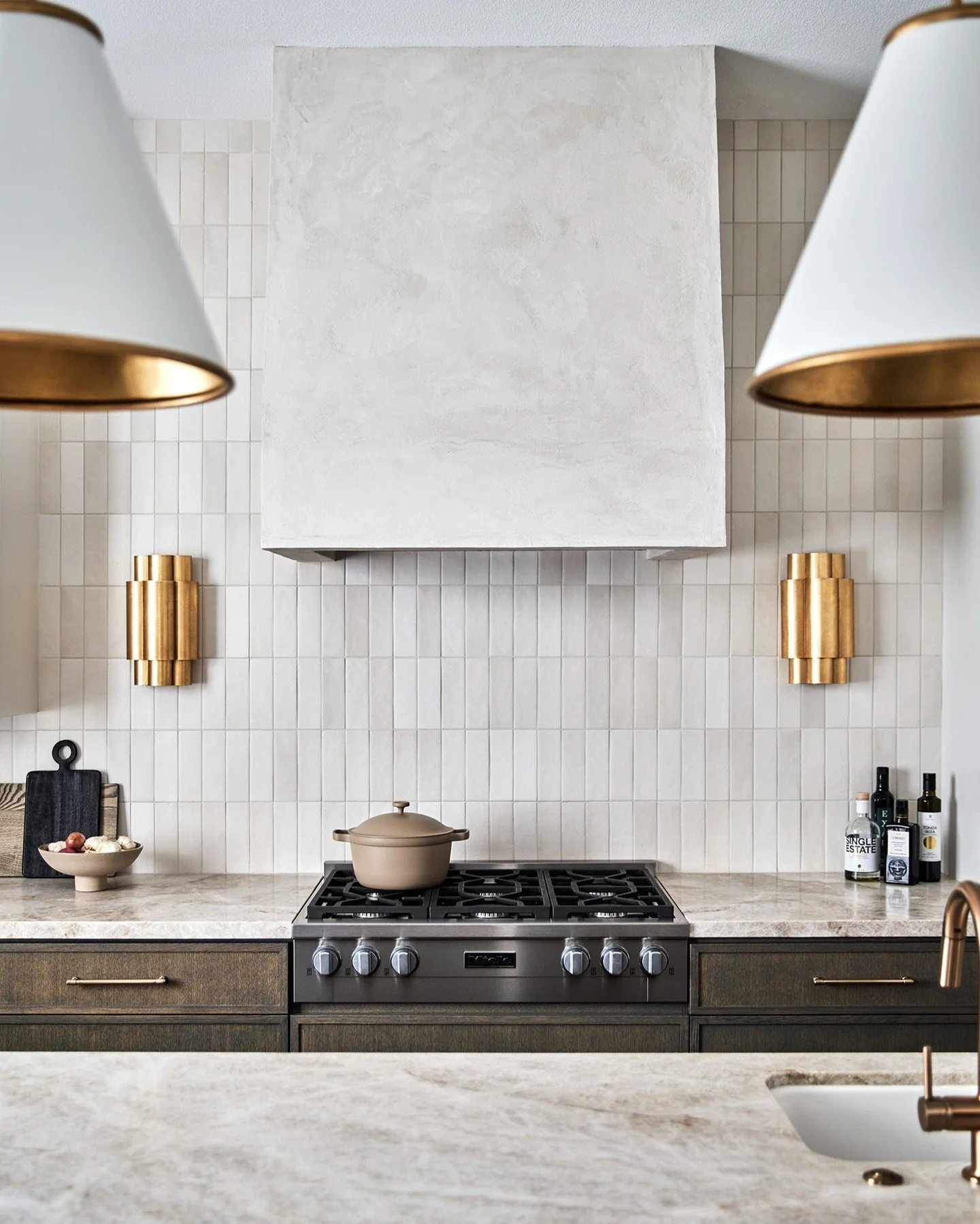 When we embark on a renovation, we consider a space from every angle, paying close attention to proportion and flow. This kitchen began dated and basic, with soffits, angles, and limited natural light. We scaled back the architecture, straightened th