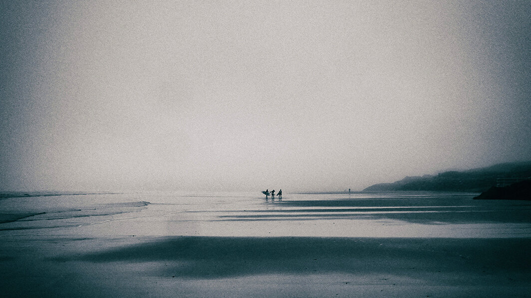 Three mystery surfers.
