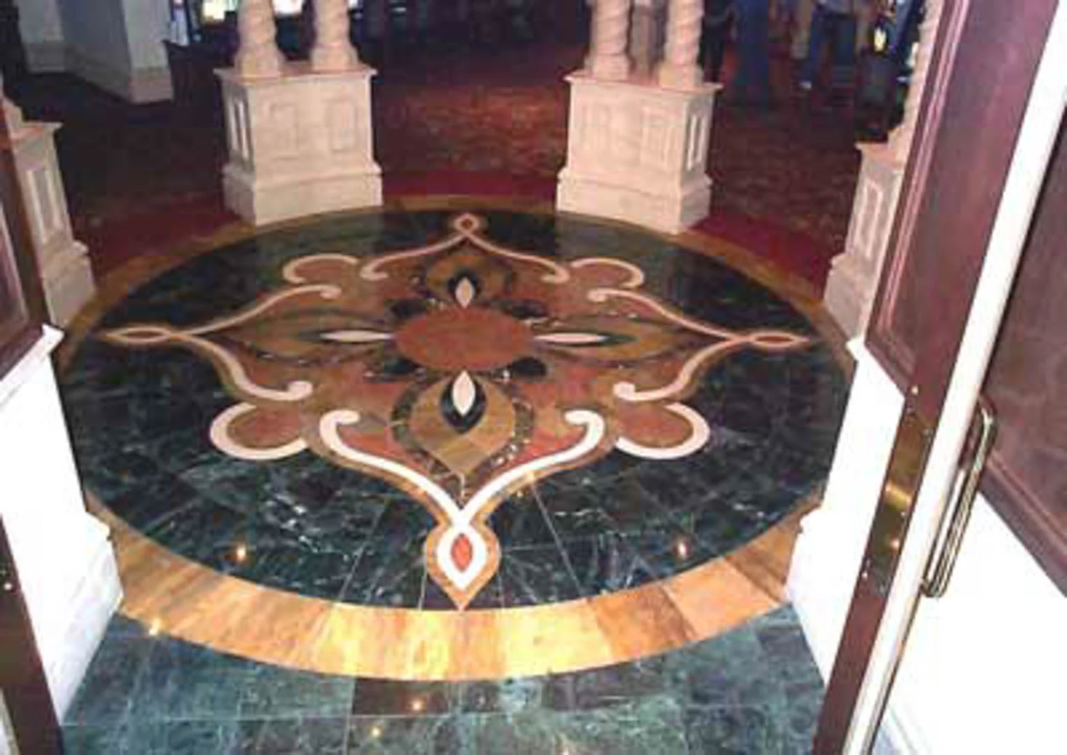 Project: Treasure Island Hotel Location: Las Vegas, Nevada Description: This waterjet medallion was fabricated utilizing 12" x 12" marble tile only. Utilizing marble tile can be cost effective and it often allows for easier transitions to carpet.