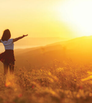 Happy-woman-standing-with-her-back-on-sunset-in-nature-iwith-open-hands.-300x336.jpg