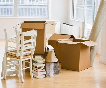 canva-moving-boxes-and-chairs-in-livingroom-MADFs90ia2U.jpg