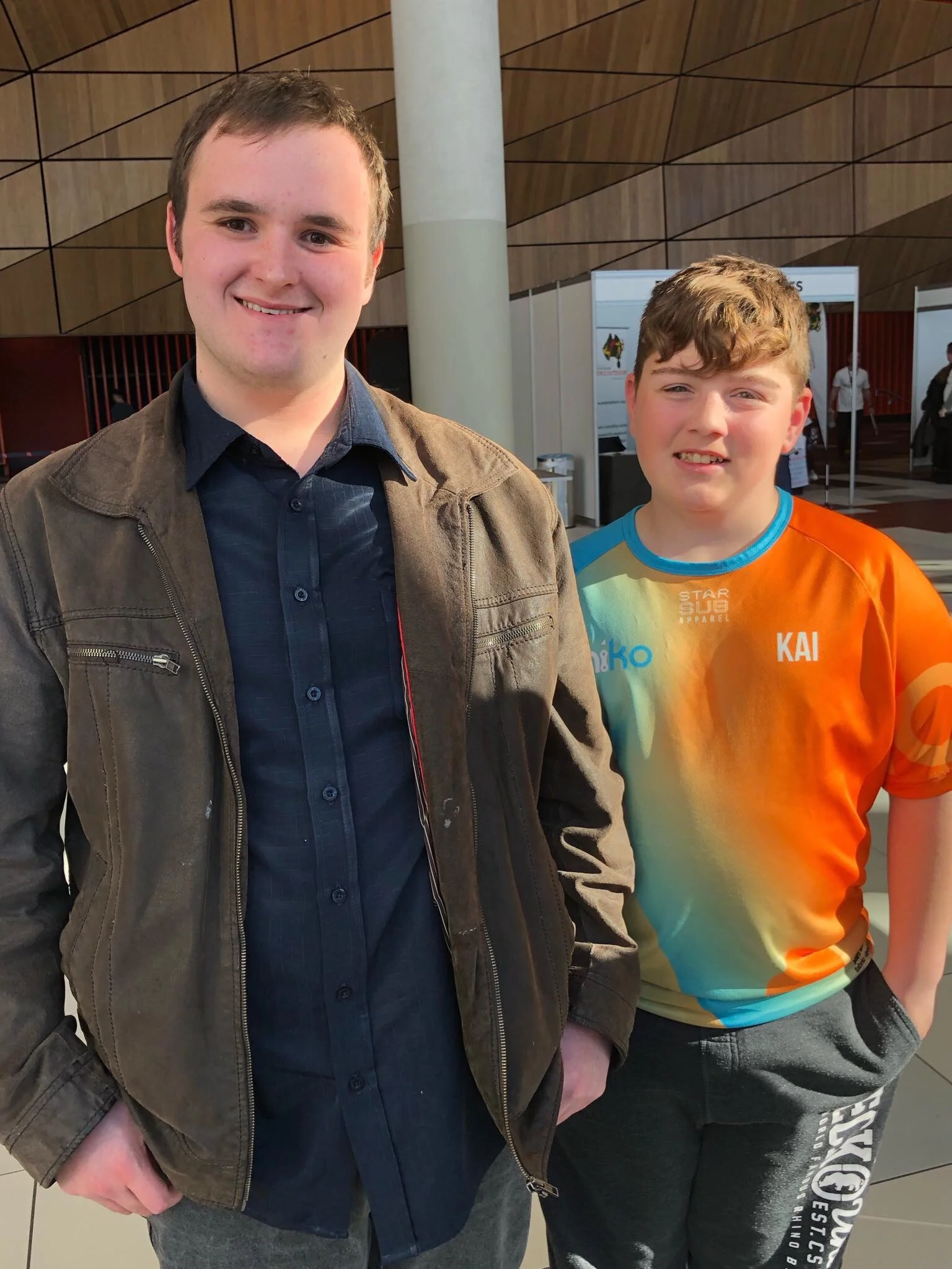 Picture Description: a photo taken at the Melbourne Convention Centre, Bryce Pace is standing next to Kai the 13 year old founder of Kaiko Fidgets.