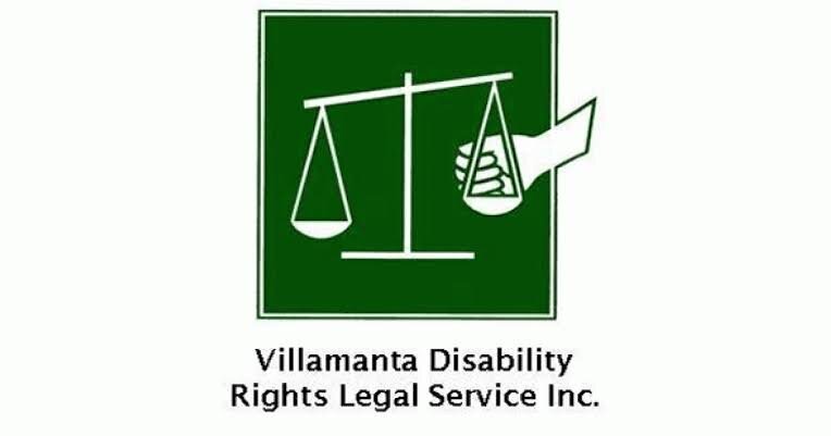 Logo for Villamanta Disability Rights Legal Service Inc. featuring a scale of justice with a hand adjusting it, on a green background.