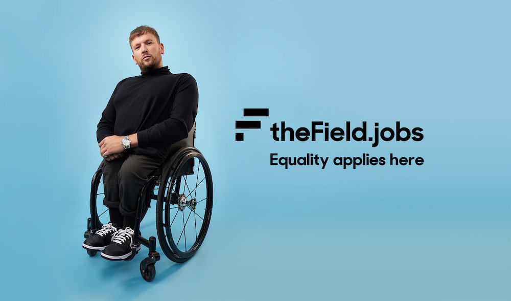 Man sitting in a wheelchair on a light blue background next to 'theField.jobs' logo and slogan 'Equality applies here.'