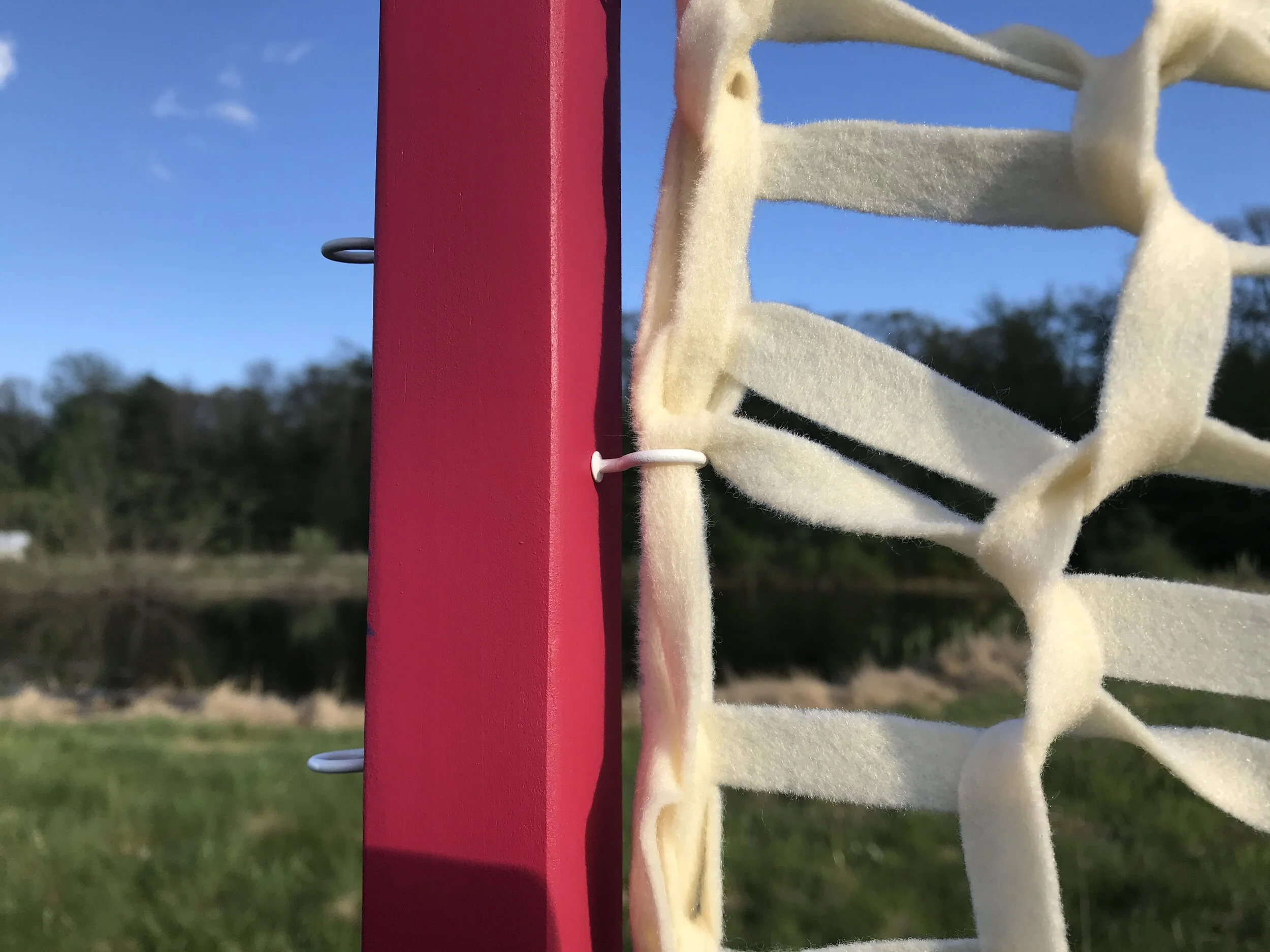   Fence for Sheep and Humans (detail),  2020, Wood, cup hooks, rocks, yarns, and poly fleece, 6’ tall, other dimensions variable 