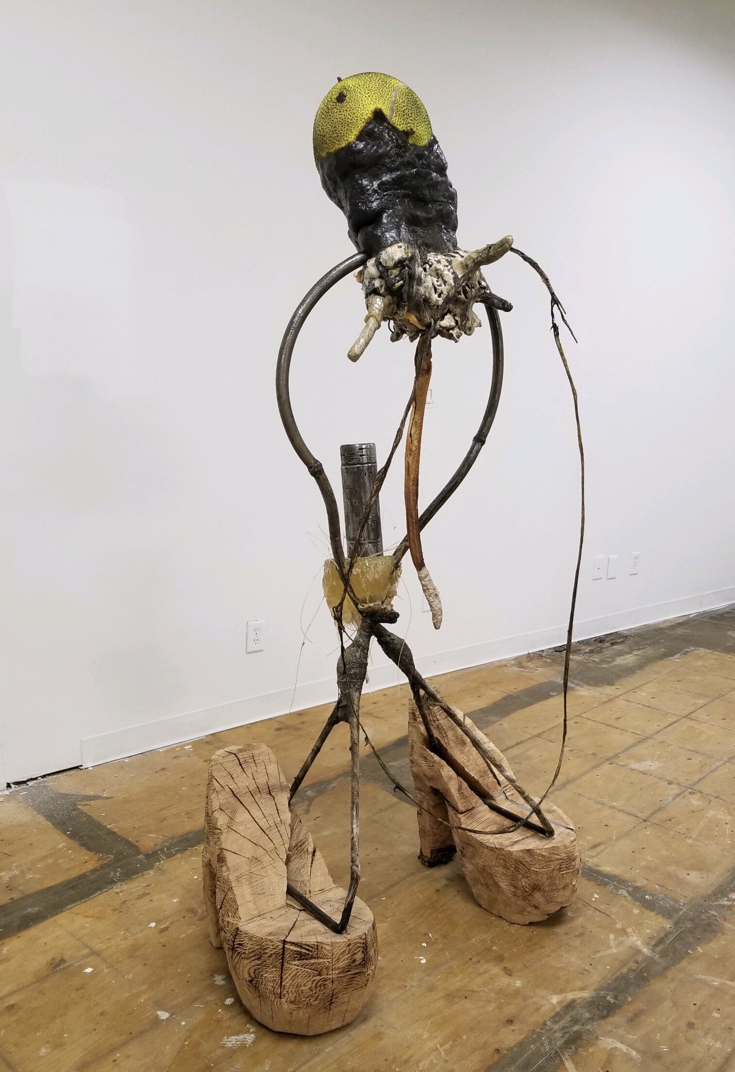 Daniel Giordano,  Study for Brother with Pet Eel and in Vicki’s Stilettos , 2016-2019, glazed ceramic, steel, wood, Amarelli liquorice, urinal cake, oversized tennis ball, eel, deep-fried batter, wire hanger, plastic wrap, tennis racket string, Plasticine clay, duct tape, epoxy, Tiger Balm, artificial teeth, 75 x 37 x 29 in.