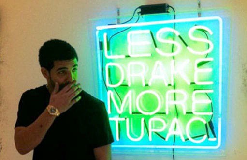 Drake posing with Patrick Martinez’s “Less Drake, More Tupac” (2011).