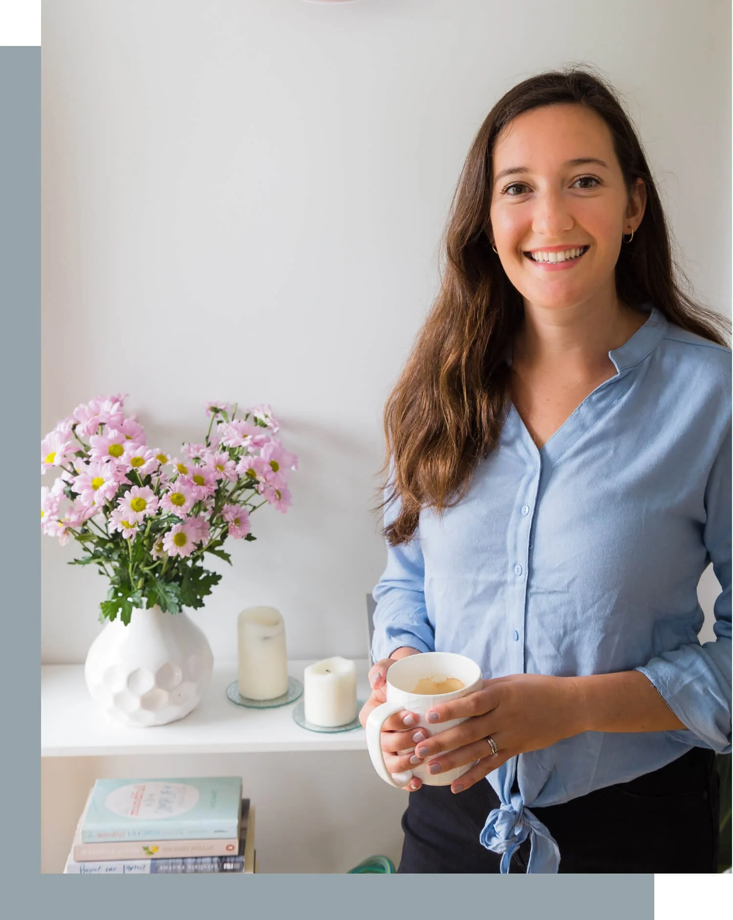 A woman named Grace holding a white coffee cup and smiling.