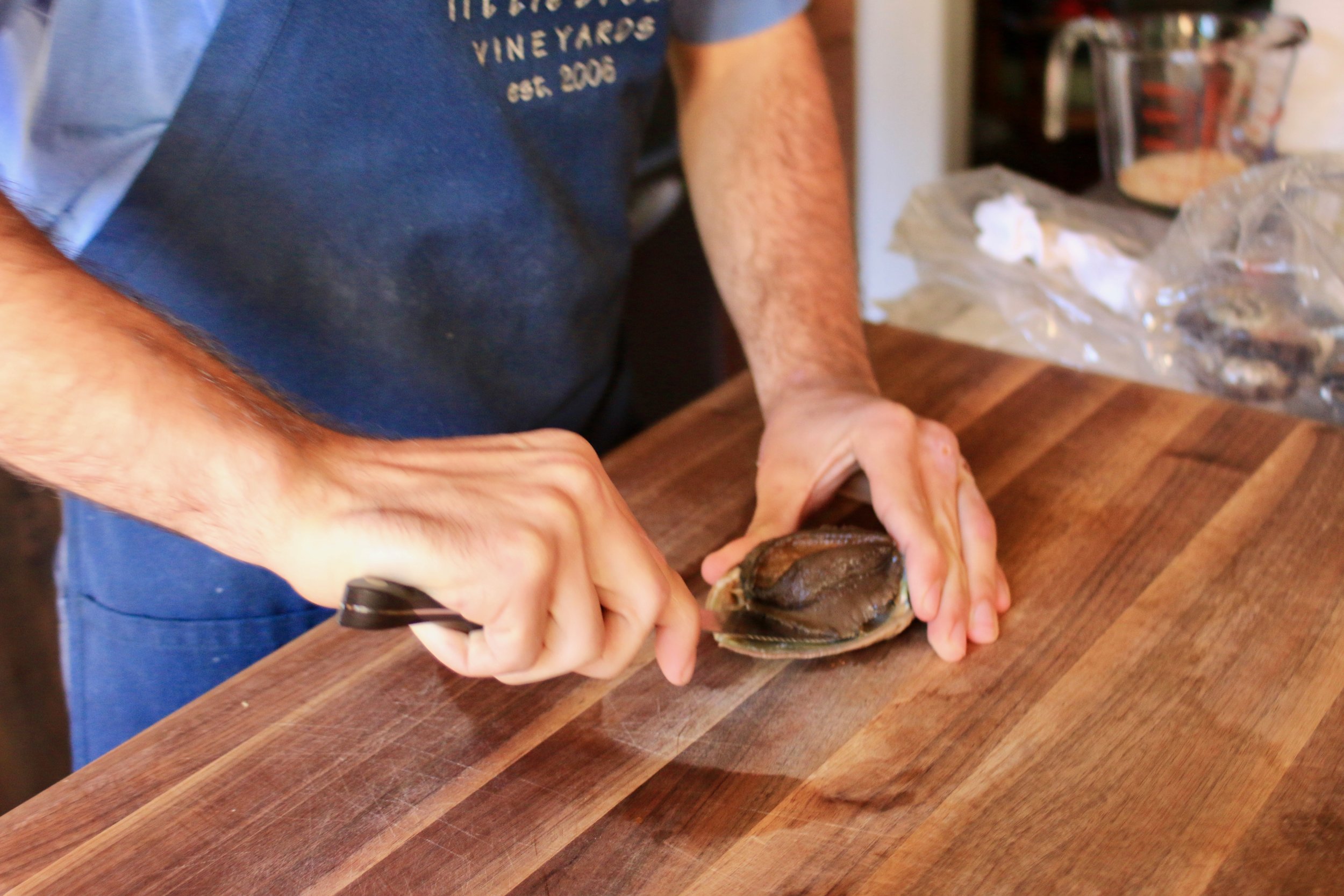 Press the knife against the shell, separate the abalone from the shell.  