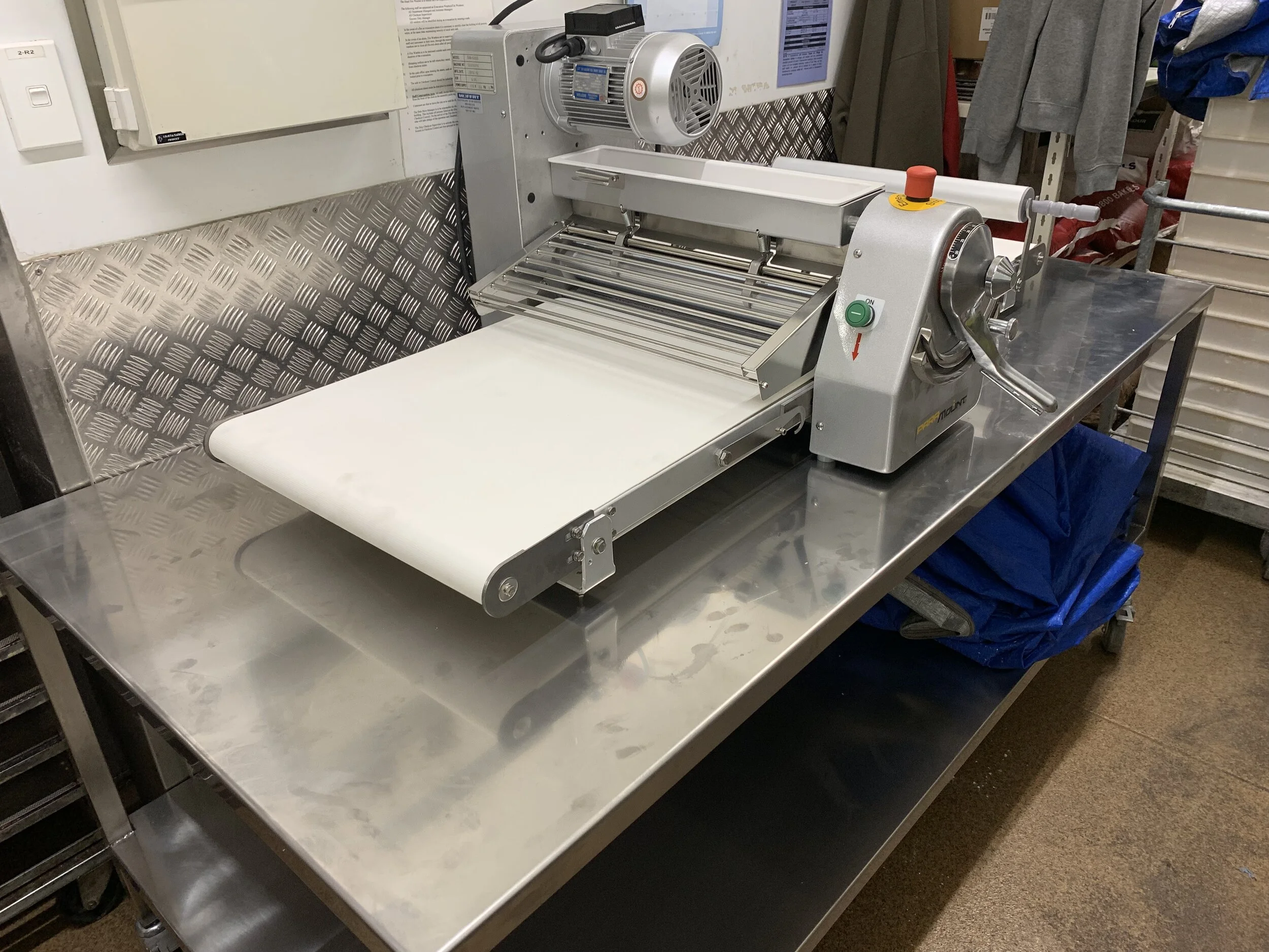 Stainless Steel work bench custom made to fit the Paramount Sheeter on top, 4 swivel lockable wheels to allow easy moving for relocation or cleaning under.