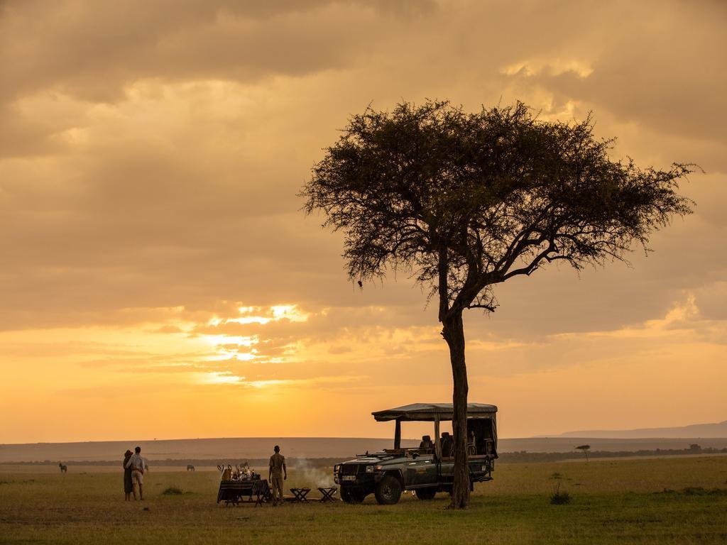 Couple enjoying a private sundowner on safari