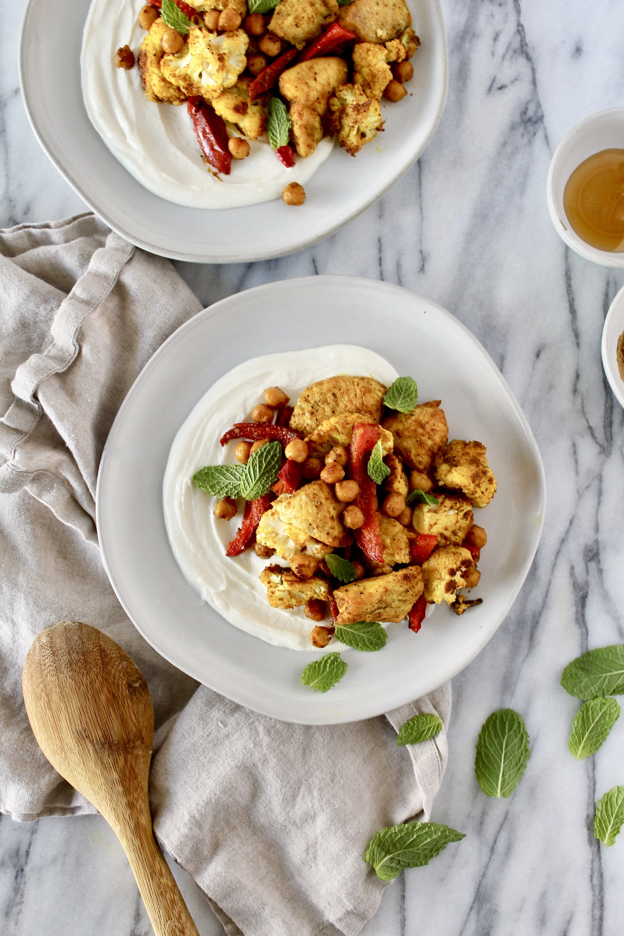 sheet pan turmeric spiced chicken, cauliflower, peppers, and chickpeas with whipped lemon honey