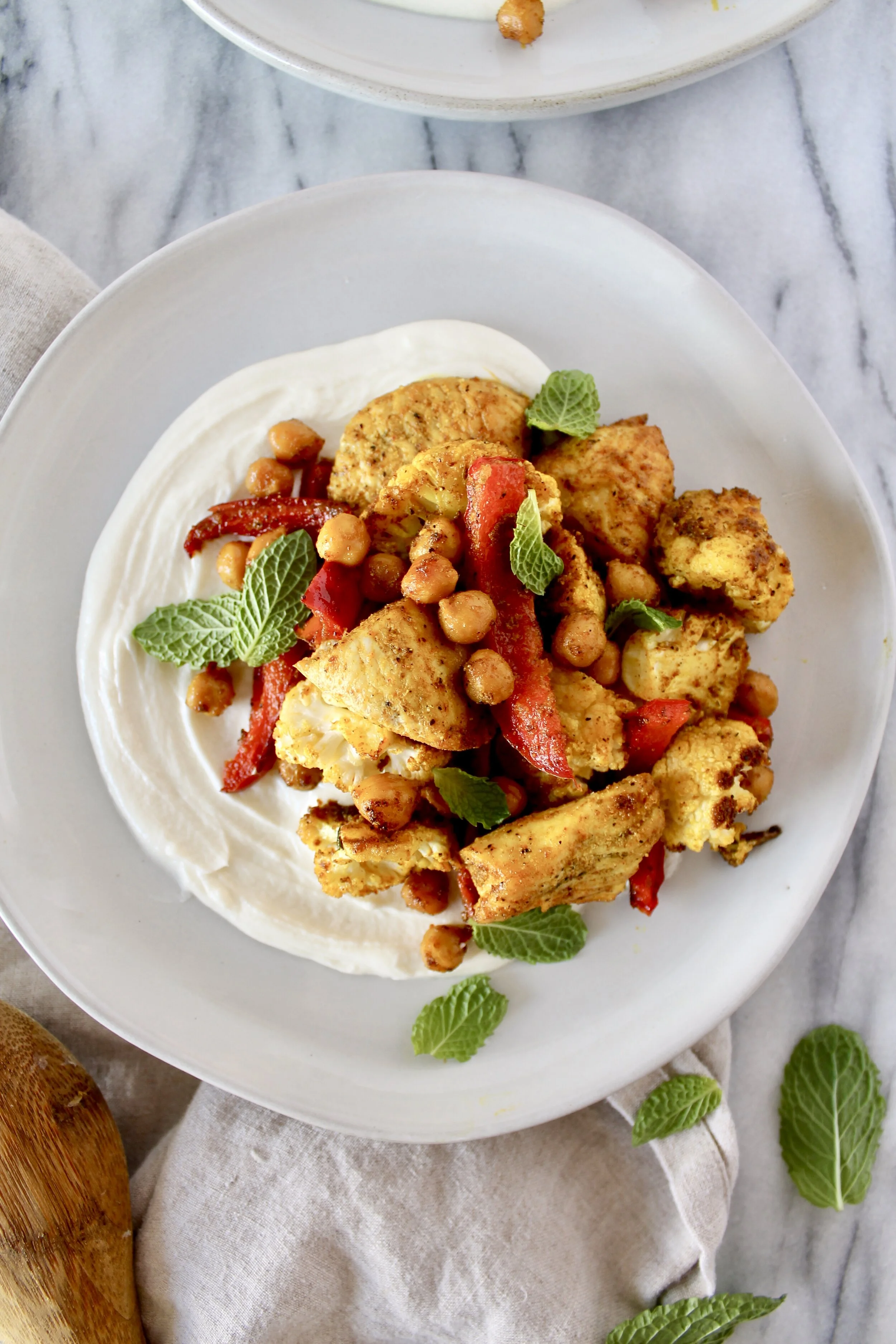 sheet pan turmeric spiced chicken, cauliflower, peppers, and chickpeas with whipped lemon honey