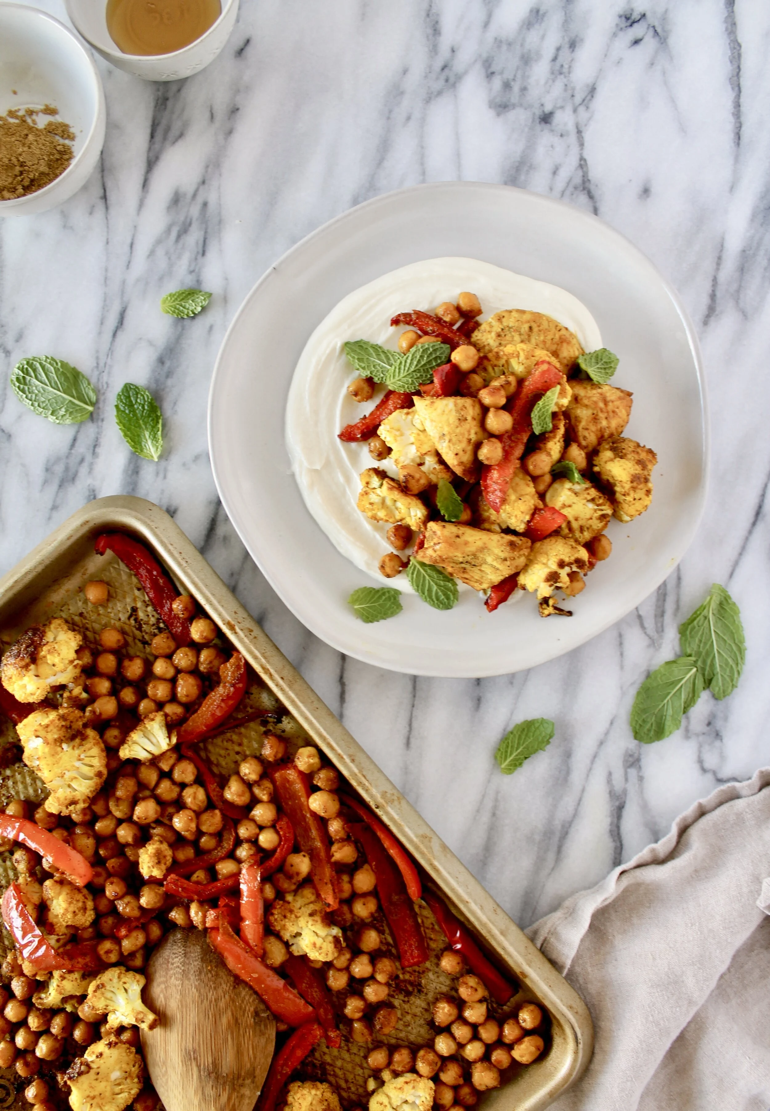 sheet pan turmeric spiced chicken, cauliflower, peppers, and chickpeas with whipped lemon honey