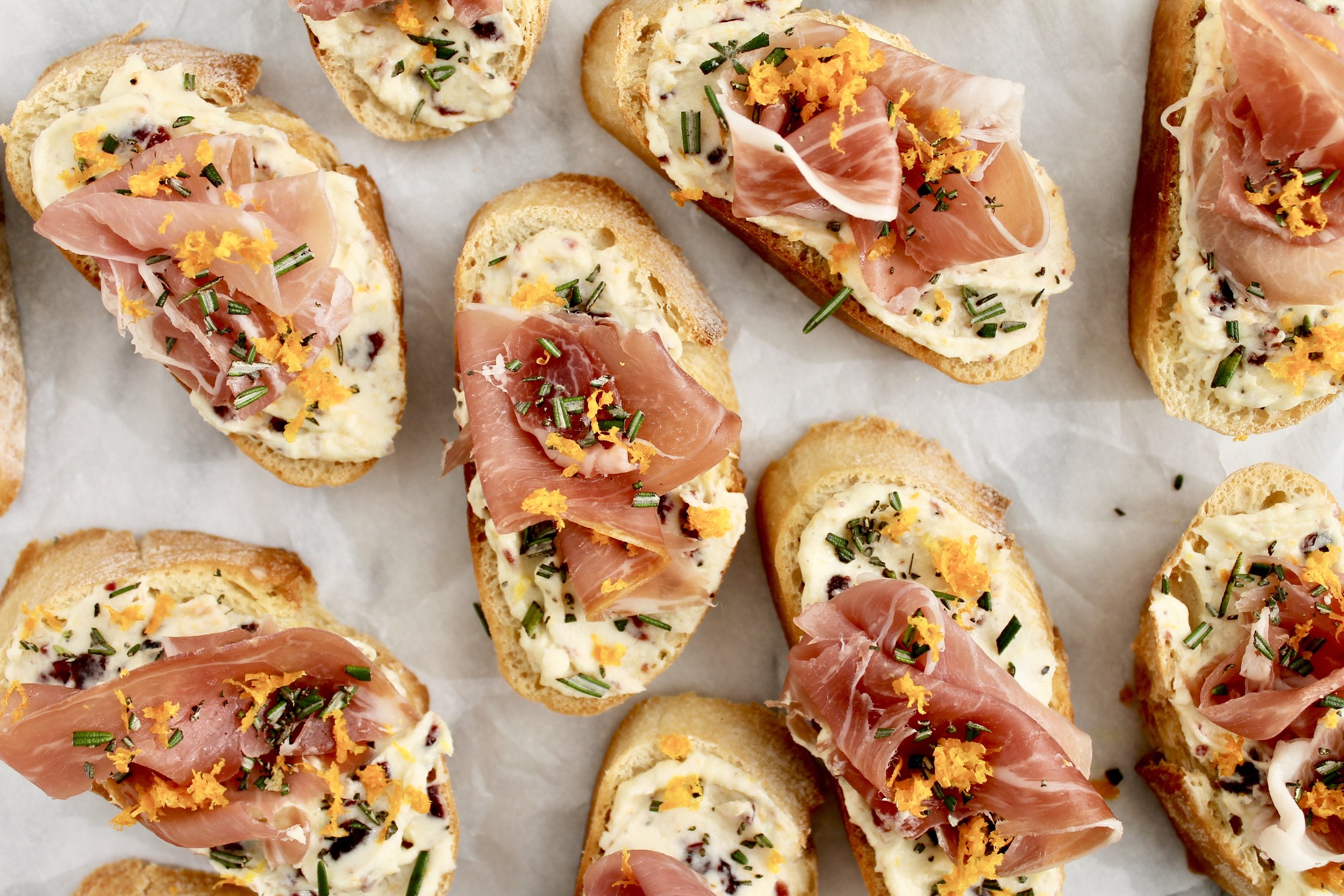 honeyed goat cheese, cranberry, rosemary, and prosciutto crostini