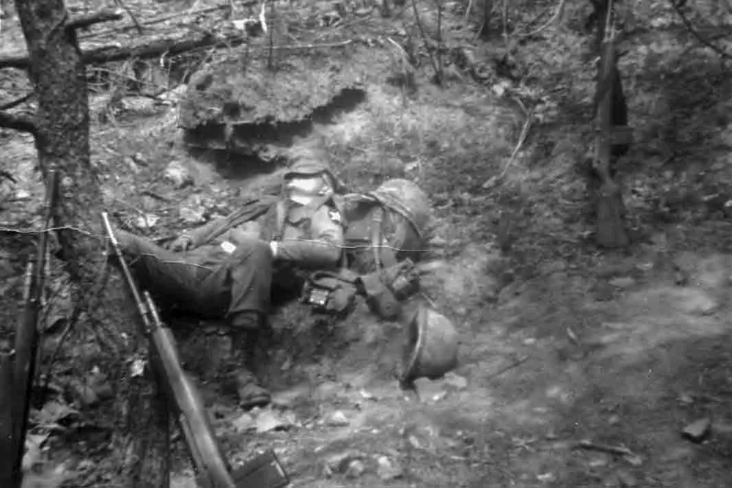 The author takes a snooze in the DMZ in the middle of a three-day patrol (Spring1968).